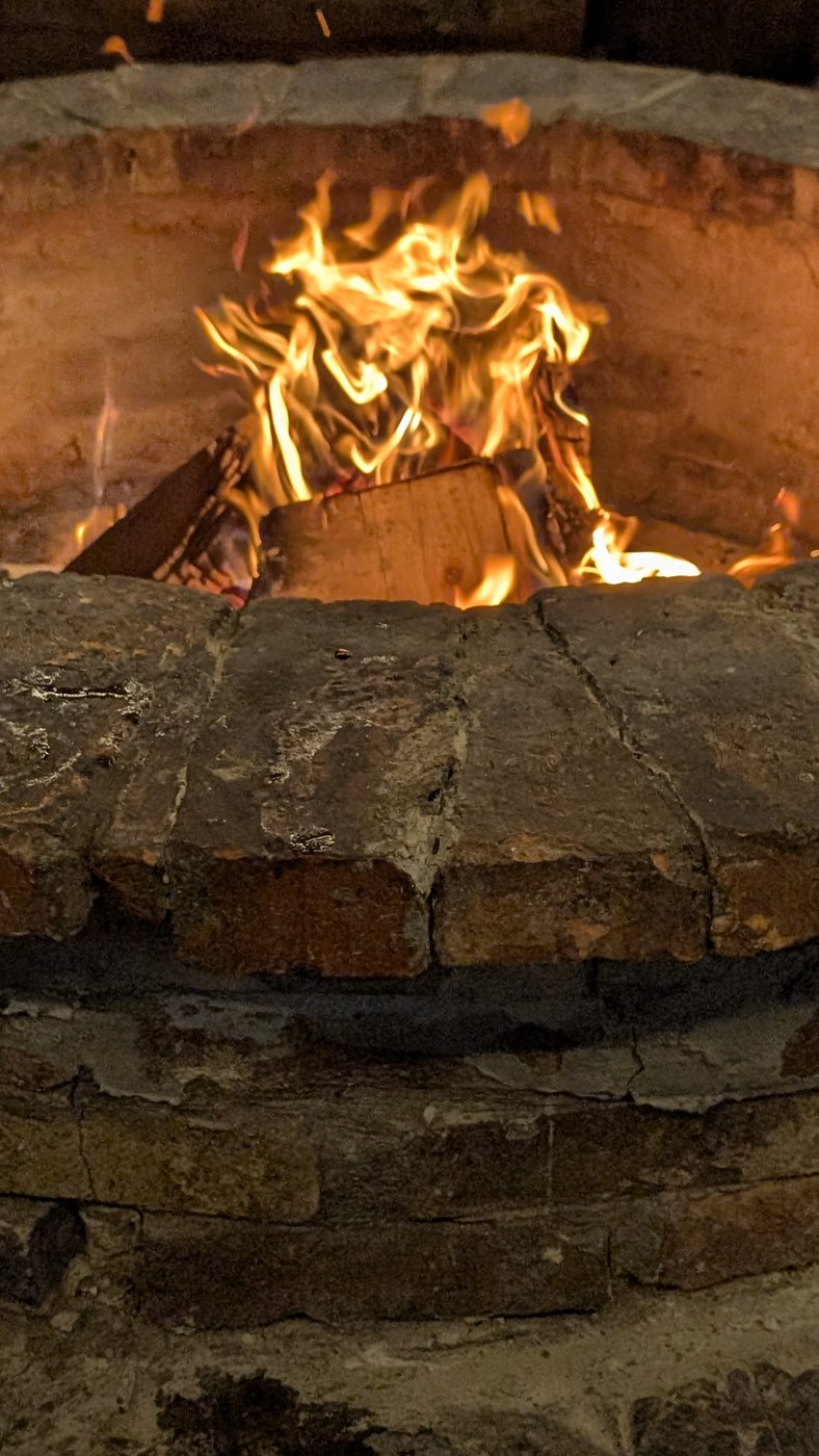 The fire in the brick hearth of the gazebo